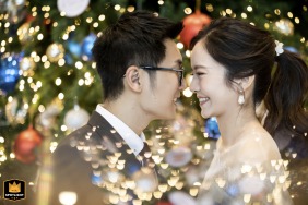   The Festive Portrait at The Athenee Hotel Bangkok features the couple radiating happiness, surrounded by celebratory tea lights, bokeh, and décor suited to the venue’s elegant atmosphere.